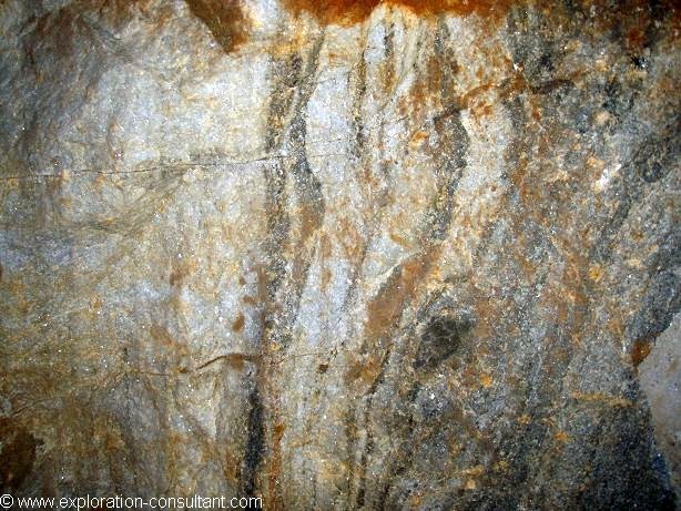 Typical tungsten skarn ore with garnet, calcite, scheelite and diopside.